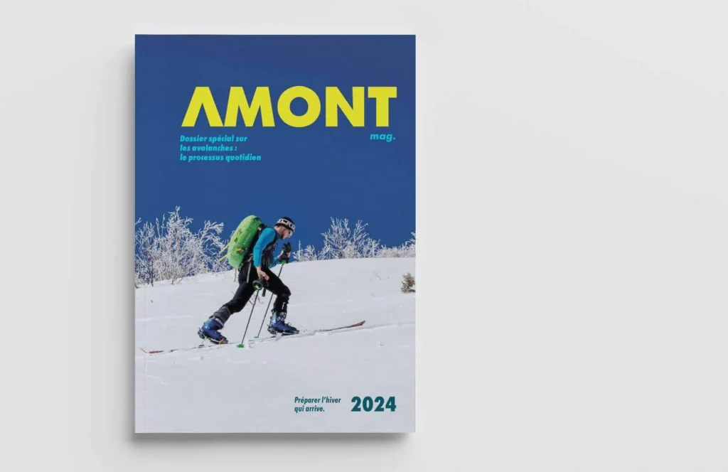 Couverture du magazine AMONT 2024 : un skieur de randonnée devant une montagne enneigée.